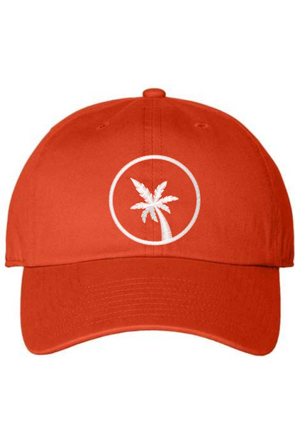 An orange baseball cap with a curved brim. The front of the hat features an embroidered seven frond Palm Tree in white thread. The cap has a visible button on the top and an adjustable strap in the back (not visible).