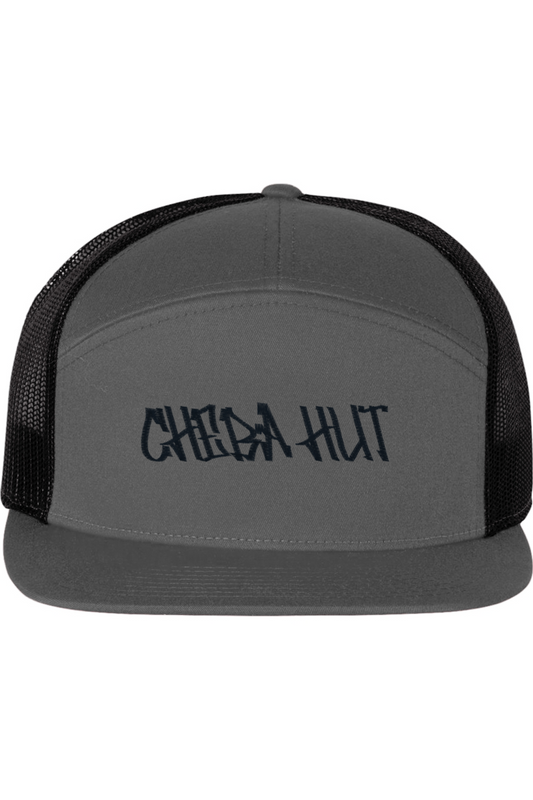 A five-panel trucker hat with a solid grey front panel and brim. The back two panels are black mesh. The front of the hat features the black stylized text 'CHEBA HUT'. The hat has a slightly curved brim and a visible button on the top.