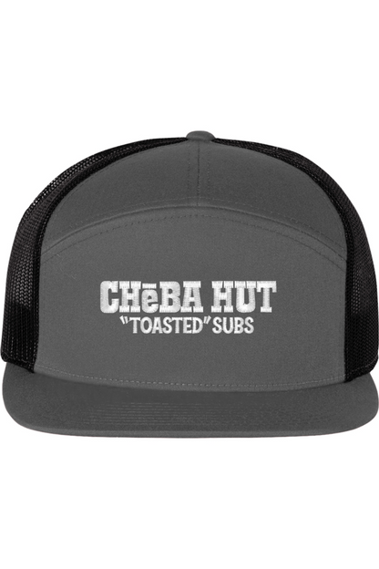 A seven -panel trucker hat with a solid grey front panel and brim. The back two panels are black mesh. The front of the hat features the white stylized text 'CHEBA HUT "TOASTED" SUBS'. The hat has a slightly curved brim and a visible button on the top.