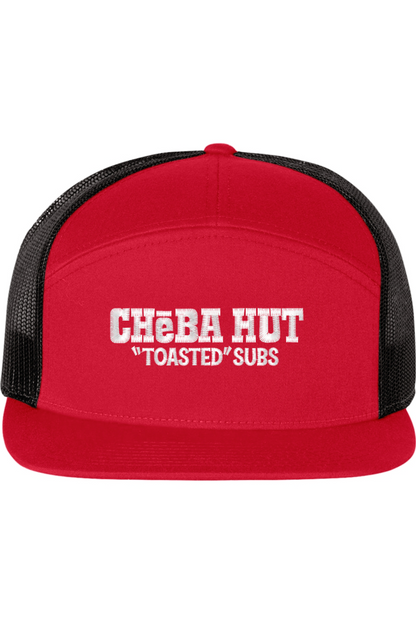 A seven -panel trucker hat with a solid red front panel and brim. The back two panels are black mesh. The front of the hat features the white stylized text 'CHEBA HUT "TOASTED" SUBS'. The hat has a slightly curved brim and a visible button on the top.