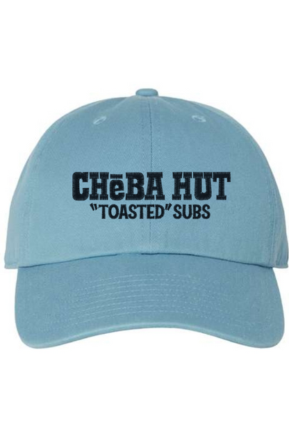 A light blue baseball cap with a curved brim. The front of the cap features the black stylized text 'CHEBA HUT "TOASTED" SUBS' embroidered across the center. The cap has a visible button on the top and an adjustable strap in the back (not visible).