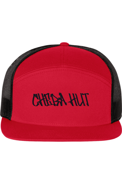 A five-panel trucker hat with a solid red front panel and brim. The back two panels are black mesh. The front of the hat features the black stylized text 'CHEBA HUT'. The hat has a slightly curved brim and a visible button on the top.