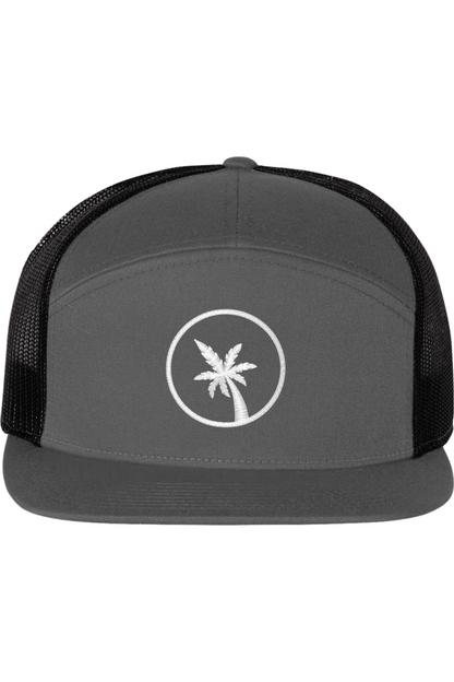 A seven -panel trucker hat with a solid grey front panel and brim. The back two panels are black mesh. The front of the hat features a seven frond palm tree in white thread. The hat has a slightly curved brim and a visible button on the top.
