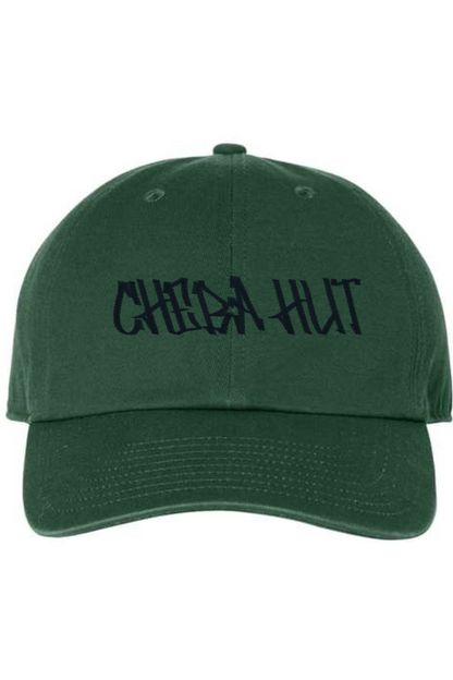 A dark green baseball cap with a curved brim. The front of the cap features the black stylized text 'CHEBA HUT' embroidered across the center. The cap has a visible button on the top and an adjustable strap in the back (not visible).