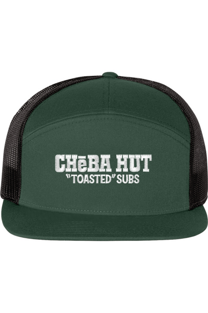 A seven -panel trucker hat with a solid green front panel and brim. The back two panels are black mesh. The front of the hat features the white stylized text 'CHEBA HUT "TOASTED" SUBS'. The hat has a slightly curved brim and a visible button on the top.