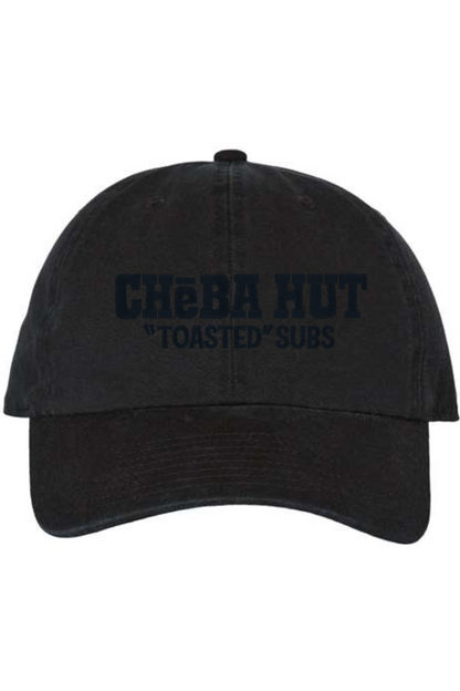 A black baseball cap with a curved brim. The front of the cap features the black stylized text 'CHEBA HUT "TOASTED" SUBS' embroidered across the center. The cap has a visible button on the top and an adjustable strap in the back (not visible).