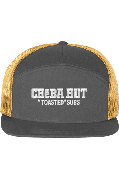A seven -panel trucker hat with a solid grey front panel and brim. The back two panels are gold mesh. The front of the hat features the white stylized text 'CHEBA HUT "TOASTED" SUBS'. The hat has a slightly curved brim and a visible button on the top.