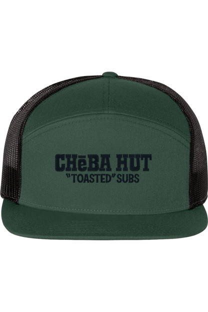 A seven-panel trucker hat with a solid green front panel and brim. The back two panels are black mesh. The front of the hat features the black stylized text 'CHEBA HUT "TOASTED" SUBS'. The hat has a slightly curved brim and a visible button on the top.
