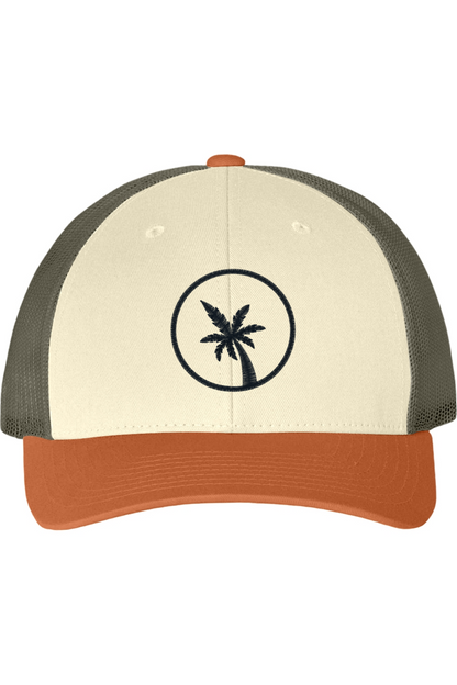 A cream and khaki trucker hat with palm tree design on a white background. The bill of the hat is burnt orange. 