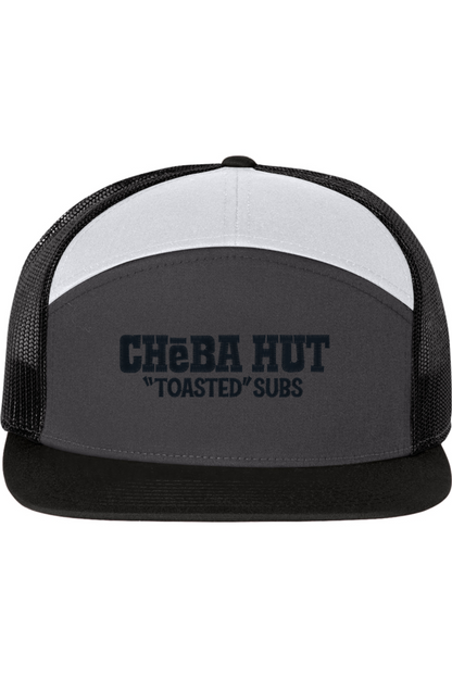 A seven-panel trucker hat with a solid grey front panel and black brim. The Top panel is white. The back two panels are black mesh. The front of the hat features the black stylized text 'CHEBA HUT "TOASTED" SUBS'. The hat has a slightly curved brim and a visible button on the top.