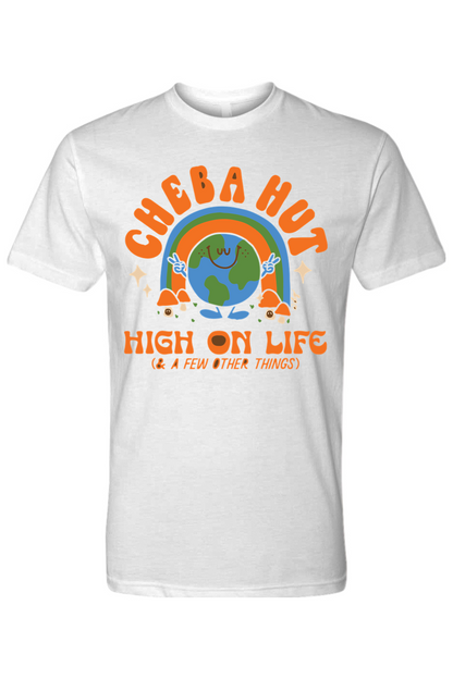 A white short-sleeved t-shirt featuring a retro-style graphic with a smiling Earth under a rainbow, palm trees, and the text 'CHEBA HUT' and 'HIGH ON LIFE (& A FEW OTHER THINGS)'.