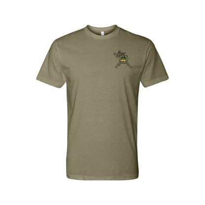 An olive green short-sleeved t-shirt featuring a rectangular, vintage-inspired graphic on the back depicting a horned, winged figure with two smaller figures and the text 'CHEBA HUT' and 'THE DEVIL'S LETTUCE'. The front of the shirt depicts a small hut with palm trees on each side. 